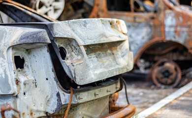 Broken and burned cars in the parking lot, accident or deliberate vandalism. Burnt car. Consequences of a car accident. Damaged by arson. Dump of civilian vehicles shot by Russian troops in Ukraine.