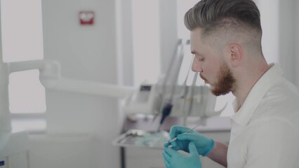 The male dentist explains to the patient the treatment plan at the dental clinic. The work of a dentist. Healthcare and medicine concept.