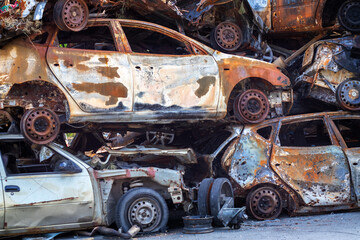 Russian invasion of Ukraine in 2022, destroyed and burned cars. Cars were beaten with shrapnel and...