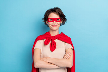 Photo of sweet adorable woman wear red cape smiling arms folded isolated blue color background
