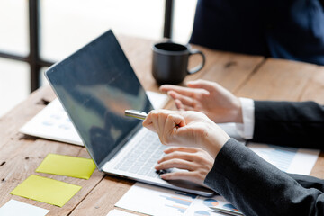 Company meeting room has businessmen and finance managers meeting together on finance topics, they are looking at information on documents and discussing together. Concept company financial management