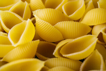 pasta Conchiglioni close-up. yellow pasta. pasta texture. Horizontal image