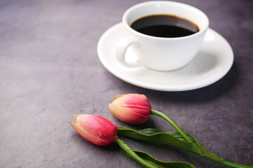 coffee, tulip flower on black background .