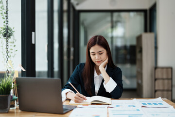 A portrait of an economist or an accountant or a financier and an investor examining budget documents and using computers to study the impact and risk assessment of corporate investment management