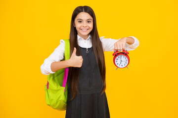 School and education concept. Back to school. Schoolchild, teenage student girl with clock alarm, time to study. Happy girl face, positive and smiling emotions.