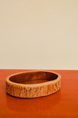 brown ceramic bowl on dark brown table with white background