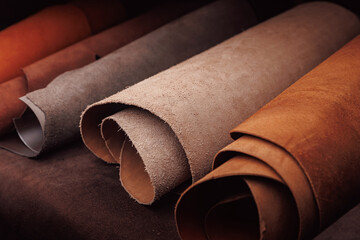 Different rolls natural leather brown and beige color dark background - Powered by Adobe