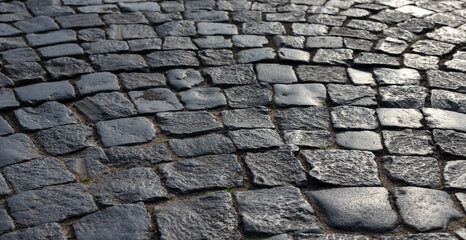 Shiny black stone pavement. Photo background