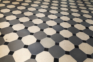 Old style stone mosaic floor tiling, geometric pattern