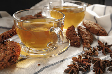 Two cups of herbal tea and cookies on kitchen cloth
