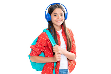 Schoolgirl, teenage student girl in headphones on white isolated studio background. School and music education concept. Back to school. Portrait of happy smiling teenage child girl.