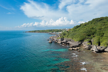 Aerial drone shot of seashore clouds ocean waves landscape