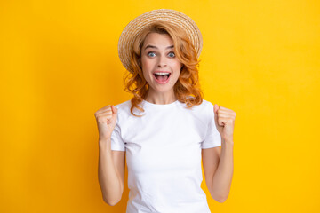 Fashion portrait pretty woman in summer straw hat over yellow background.