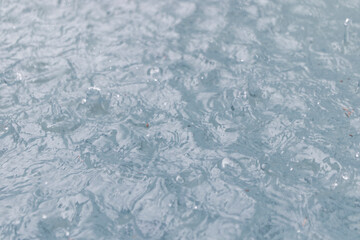 raining on lake water, splashing water