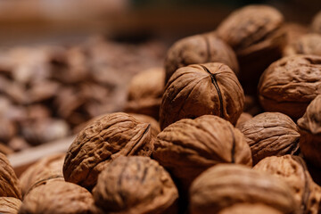 Raw organic walnuts for sale in the market. Walnut background texture