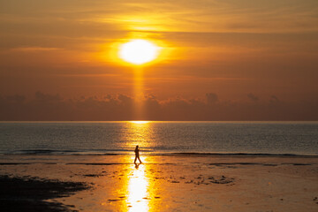 Fototapeta premium Silhouette of walking man against sunrise..