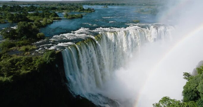 Spectacular high aerial view looking through a rainbow at the scenic Victoria falls. Unesco world heritage site