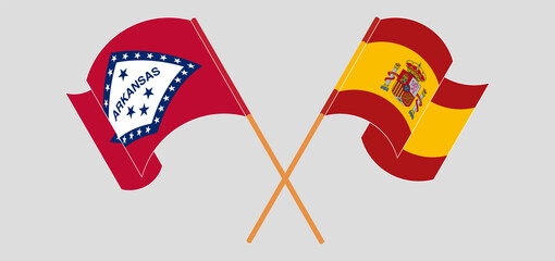 Obraz premium Crossed and waving flags of The State of Arkansas and Spain