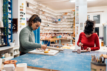 Fototapeta premium Concentrated Women in Pottery Class