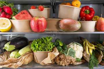 Opened refrigerator full of vegetarian healthy fresh fruit, vegetables, rich in antioxidant, vibrant food inside on fridge. Healthy nutrition. Detox. Diet. Zero waste grocery shopping concept. 