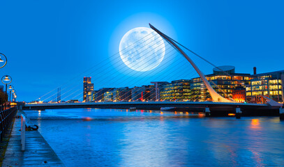 Samuel Backett Bridge (Harp Bridge) at twilight blue hour with full moon - River Liffey, Dublin ...