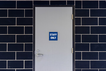 Staff only sign. Area for staff. Brick wall background.