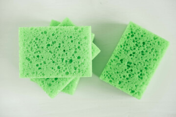 Green sponges for cleaning on a white background