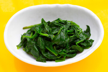 Boiled spinach in white bowl
