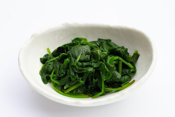 Boiled spinach on white background.