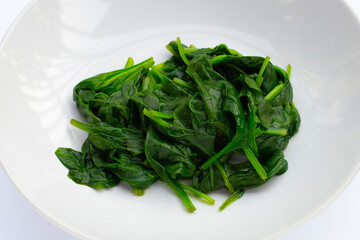 Boiled spinach on white background.