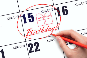 The hand circles the date on the calendar 15 August, draws a gift box and writes the text Birthday....