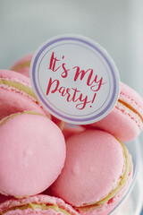 Pink french macaroons on plates. Dessert table with a macaroons composition. Candy bar	