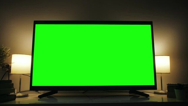 LSD smart TV screen with a blank green background in the living room. Chroma key screen for advertising.