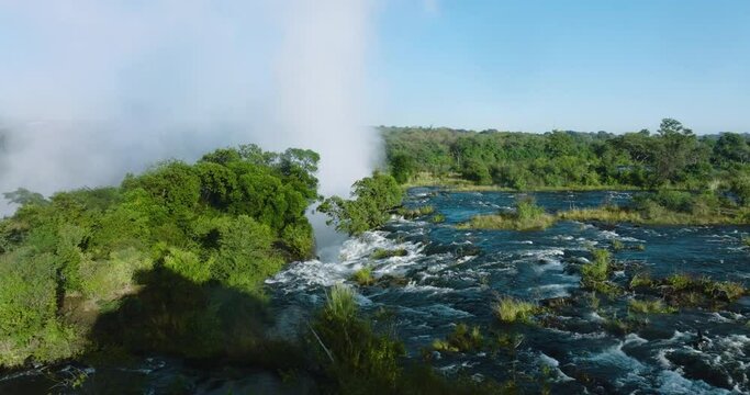 Spectacular close-up aerial view of water flowing down the Zambezi river and gushing over the edge at the scenic Victoria falls. Unesco world heritage site