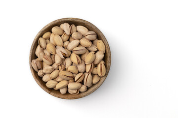 wooden bowl of unpeeled pistachio isolated on white background
