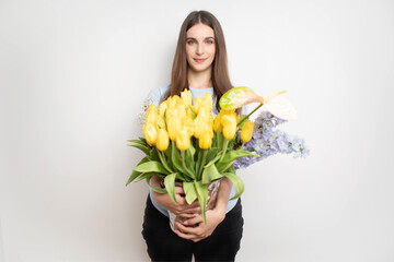 Young happy woman holding different flower. Florist with flower