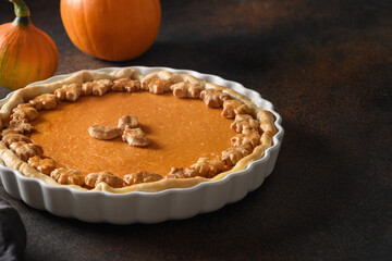 American Pumpkin Pie with cinnamon for autumn holiday on black background with copy space. Thanksgiving Day.