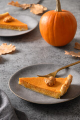 American Pumpkin Pie for autumn holiday on gray background. Vertical format. Close up. Happy Thanksgiving Day.