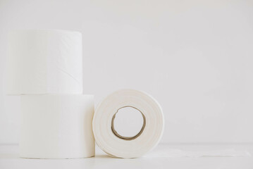 Rolls of white toilet paper on a white background