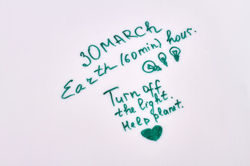 Fototapeta premium 30 march earth hour. Turn off the light save plannet. Handwriting on white background.