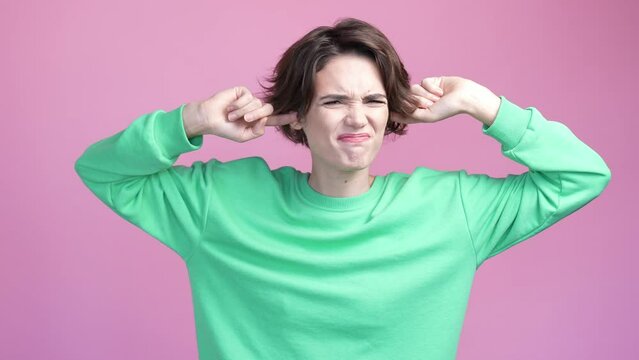 Lady plug ears fingers not like loud volume isolated pastel color background