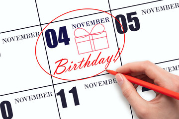 The hand circles the date on the calendar 4 November, draws a gift box and writes the text Birthday. Holiday.