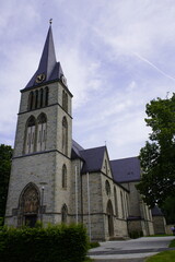 Fototapeta na wymiar The Catholic parish church of the Holy Cross is a listed church building in Altenbeken, a municipality in the Paderborn district in North Rhine-Westphalia. Germany