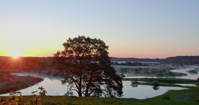 sunrise over the river from which steam emanates in russia, the middle strip, the national park, the pushkin mountains