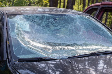 Close-up of a car with a broken windshield after a fatal crash. Consequence of a fatal car...