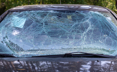 Close-up of a car with a broken windshield after a fatal crash. Consequence of a fatal car...