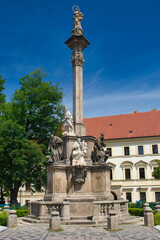 Sandstone Marian Plague Column in Hradčany. Prague town in summer cloudy day. Baroque architecture. Czech Republic.