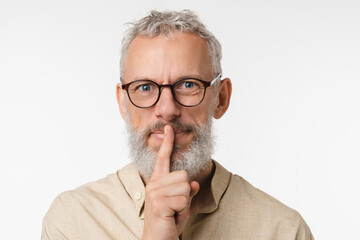 Top secret rumor gossip. Caucasian mature middle-aged man wearing glasses gesturing finger on lips...