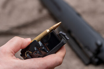 A hunter loads his hunting rifle with a magazine