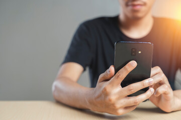 Close-up of male hands using smartphone